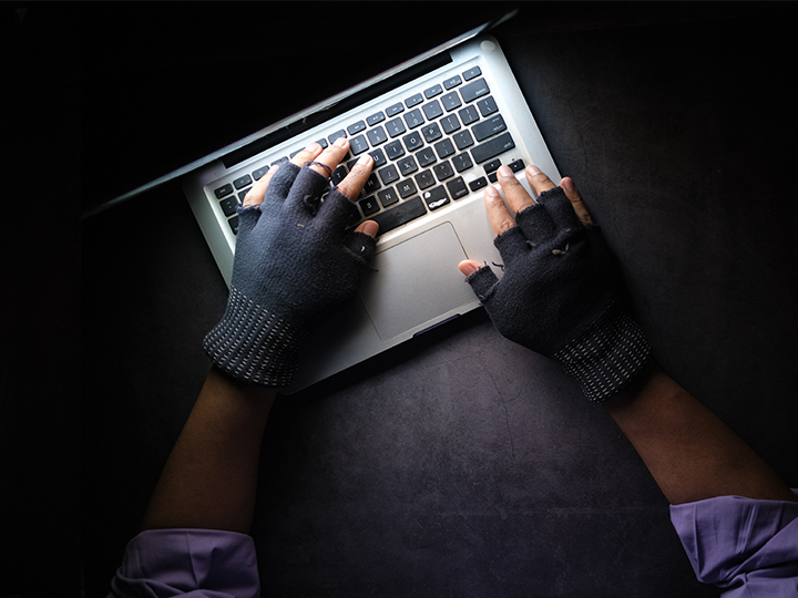 Zu sehen sind behandschuhte Hände, die einen Laptop bedienen. Bild: Unsplash/Towfiqu barbhuiya