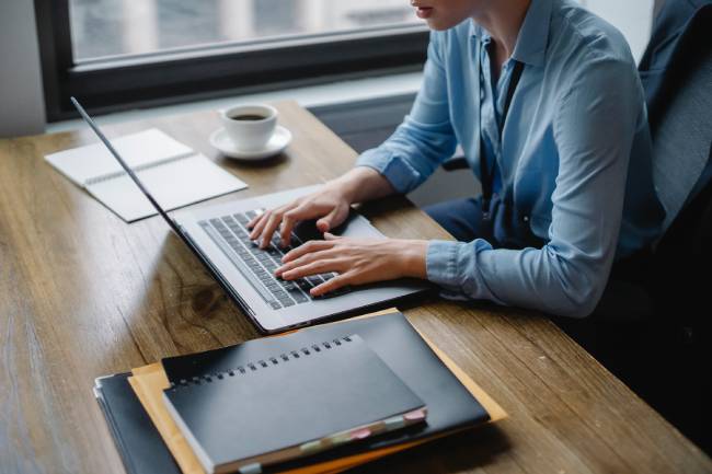 Zu sehen ist eine Frau am Laptop, die die Zwei-Faktor-Authentifizierung einrichten, damit es nicht heißt: LinkedIn gehackt. Bild: Pexels/Sora Shimazaki